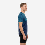 Custom blue soccer training jersey showing teal grid sleeve panel and athletic cut, left side view on male model