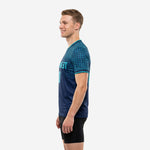 Custom blue soccer training jersey with teal contrast cuff trim and navy body, right side view on male model