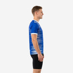 Custom blue and white training jersey left side view showing full-dye sublimation stripe pattern and white sleeve cuff trim on mens model