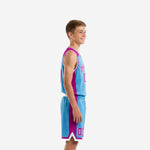 Side view of custom blue and purple youth basketball uniform showing jersey side panel and matching shorts with purple leg insert