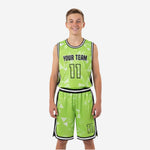 Custom boys basketball uniforms in lime green with white triangle pattern, black side panels, and player number 11 on jersey and shorts - front and back view