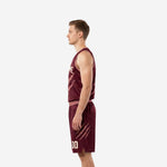 Opposite side view of the custom burgundy basketball uniform set showing continuous claw-mark sublimation across jersey and shorts leg panel