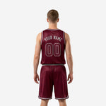 Opposite side view of sublimated burgundy basketball jersey and shorts set showing silver V-notch hem detail and elastic waistband on shorts