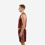 Side view of men's burgundy basketball uniform showing full-length gold geometric side panel running from armhole to shorts hem