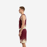 Left side view of burgundy basketball uniform set showing V-neck binding and splash pattern continuity across jersey and shorts