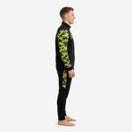 Custom camo soccer tracksuit side view showing Neon Yellow digital camo sleeve and pant side panel on male model