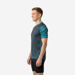 Close-up of teal camo-hex sleeve detail on custom charcoal soccer training jersey with double-stripe cuff