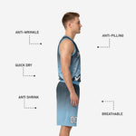 Back view of custom sublimated carolina blue basketball uniform showing player name and number print zones on charcoal and blue gradient jersey