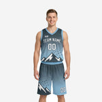 Custom carolina blue basketball uniforms with charcoal gradient and pixel mountain graphic, full two-piece set front view on male model
