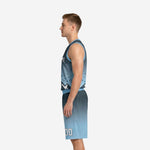 Side view of carolina blue and charcoal gradient basketball uniform showing V-neck binding and armhole edge on sleeveless jersey with matching shorts
