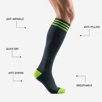 Charcoal and neon green soccer socks heel and toe panel detail showing contrast color construction