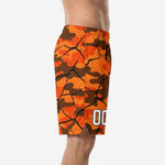 Front view of custom orange and brown camo basketball shorts with cracked-earth fracture graphic and elastic drawcord waistband