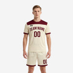 Custom cream and maroon men soccer outfits front view showing team name and number on jersey with matching shorts