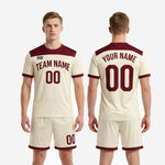 Custom cream and maroon men soccer outfit back view showing player name number and maroon contrast trim full kit