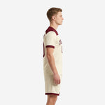 Custom cream maroon men soccer uniform side view showing maroon yoke panel cuff trim and matching shorts hem band