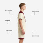 Custom cream soccer shorts with maroon hem band and sublimated player number on left leg matching jersey kit