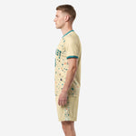 Men's custom cream soccer uniform side view with teal collar trim, full-dye sublimation splash print across jersey and shorts