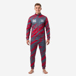 Custom crimson and charcoal red and black soccer tracksuit front view on male model showing full-zip jacket and tapered pants with slash graphic print