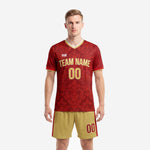 Custom crimson and gold soccer team uniform set for men, front view showing baroque floral sublimation print and Vegas Gold team name