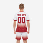 Close detail of custom crimson soccer jersey with white gradient fade and contrast crew neck trim