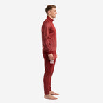 Custom crimson soccer tracksuit side view showing tapered pant leg with player number 00 and dot-burst pattern on jacket