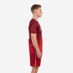 Custom crimson soccer uniform with white side panels and v-neck collar, left side view