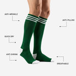 Dark green custom soccer socks showing white reinforced heel and toe zones on male model