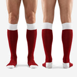 Full-length profile of custom red socks soccer in dark red and white over-the-calf length on adult male model