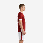 Detail view of custom red soccer uniform white shorts with dark red side stripe panel and leg number