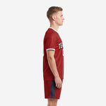 Custom red soccer uniform left side view displaying charcoal side panel on matching shorts