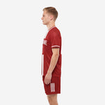 Custom dark red stripe soccer uniform side view showing full sublimated dark red shorts with three white leg stripes