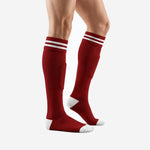 Red and white soccer socks side angle view displaying knee-high length and white contrast cuff stripes