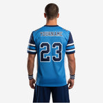 Opposite side view of royal blue and navy sublimated football jersey showing white flank panel and navy V-neck collar on male model