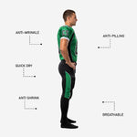 Back view of custom American football uniform in green and black showing back number, nameplate area on jersey, and green side panel running full length of black football pants
