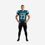 Custom football uniform sets in teal and black with V-neck jersey, black shoulder panels, front number 23, and matching black pants with teal side stripe - front view