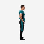 Side view of teal and black custom football uniform sets showing the full-length teal pant stripe and black shoulder panel angled from collar to armhole