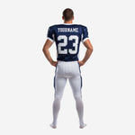 Custom football uniforms with logo - back view of navy jersey showing back number, player nameplate area, and white curved side panel tapering to hem