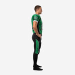 Green and black custom American football uniform with V-neck collar, angled black shoulder panels, white sleeve trim, and large front number on jersey, front view