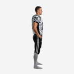 White and black custom football uniform with logo on left shoulder, front number 75 in black, team name across chest