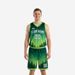 Custom forest green basketball uniforms two-piece set with lime green gradient and pine tree hem graphic, front view on male model