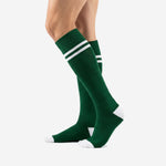Forest Green custom soccer socks showing double white calf bands and reinforced white heel, angled view
