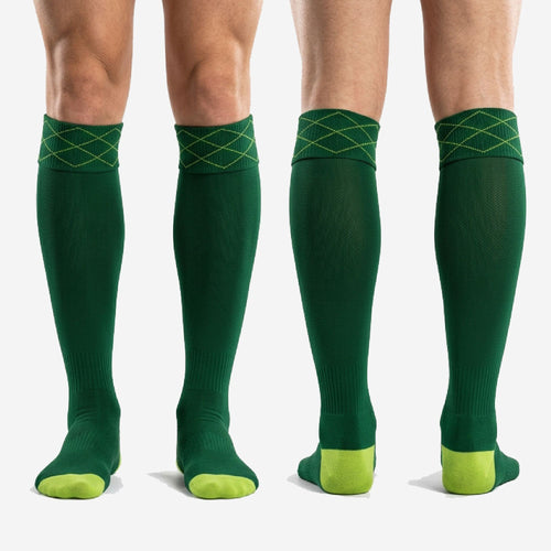 Full-length profile of custom forest green soccer socks with lime green cuff stitching and contrast footbed panels