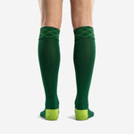 Close detail of diamond argyle knit cuff pattern in lime green thread on custom forest green soccer socks