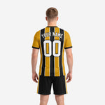 Close detail of sublimated gold and black pinstripe soccer jersey with crew neckline