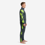 Side view of custom graphite neon green mens soccer tracksuit set showing splash print on sleeves and side panel of tapered pants