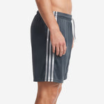 Custom gray soccer shorts showing white double stripe along the side panel, left side view on male model