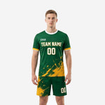 Custom Forest Green and Athletic Gold soccer uniform front view showing splash print jersey and matching shorts on male model