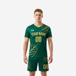 Custom green and gold soccer uniforms front view showing leaf print jersey and matching shorts on adult male model
