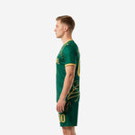 Green soccer uniforms side view right showing V-neck collar gold trim and botanical print detail