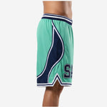 Side view of custom green and white basketball shorts showing the curved navy wave panel, white outline stripe, and V-notch hem split